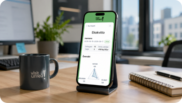 Visit Umeå eco-receipt displayed on a phone beside a branded mug in an office
